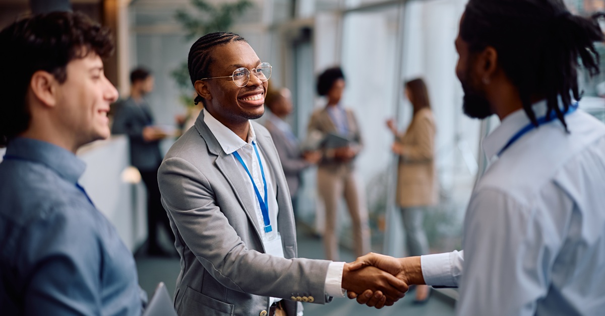 Young man shakes hands with a colleague